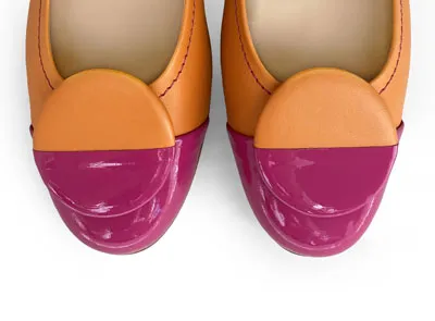 Orange leather ballet flats with fuchsia patent leather toe and stud