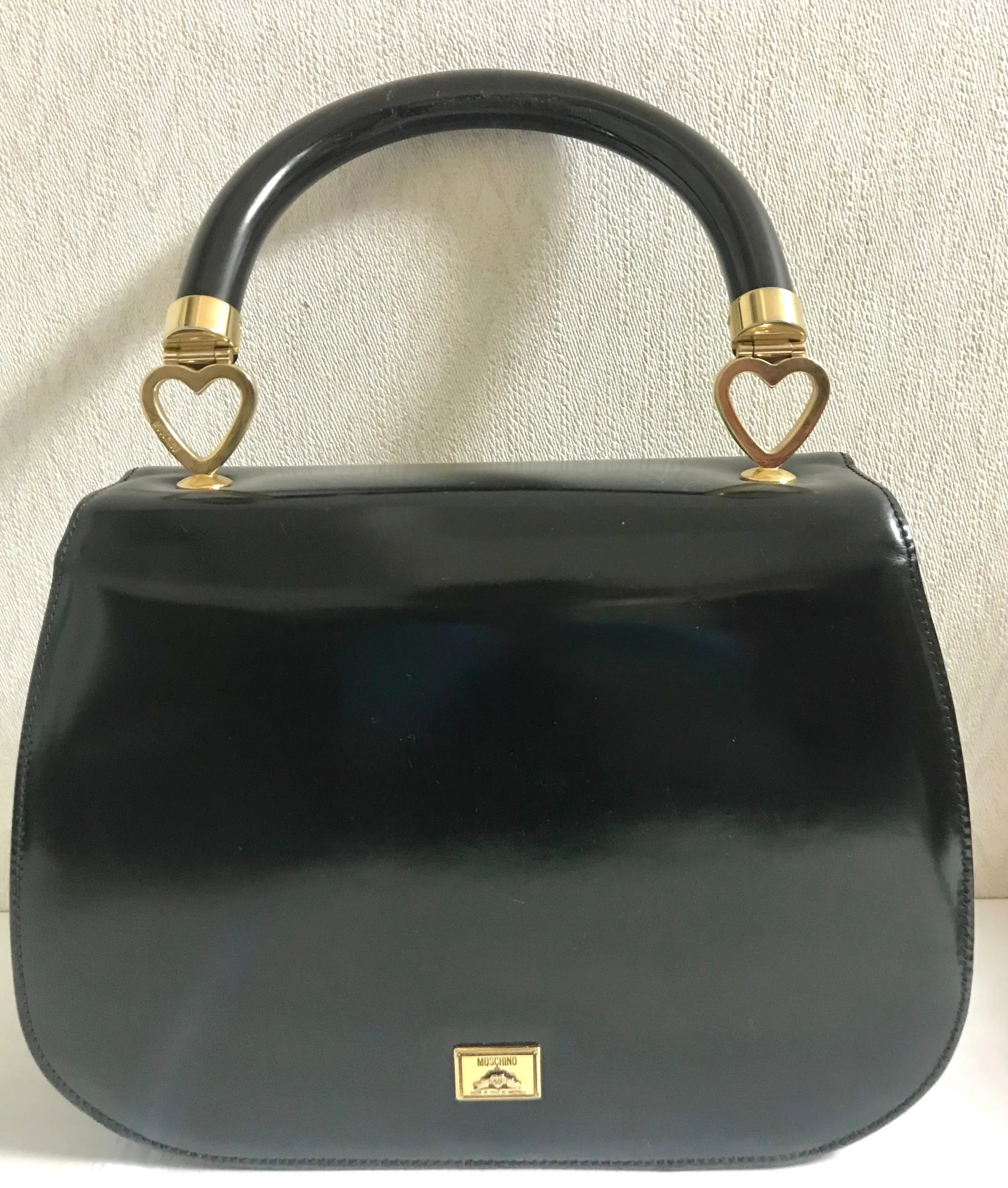 Vintage MOSCHINO black patent enamel Kelly style handbag with M logo and heart motifs. Masterpiece by Redwall. 050323re4